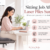 Woman working at a desk after laser piles surgery, with recovery tips from Dr. Neha Mutha, Pune.